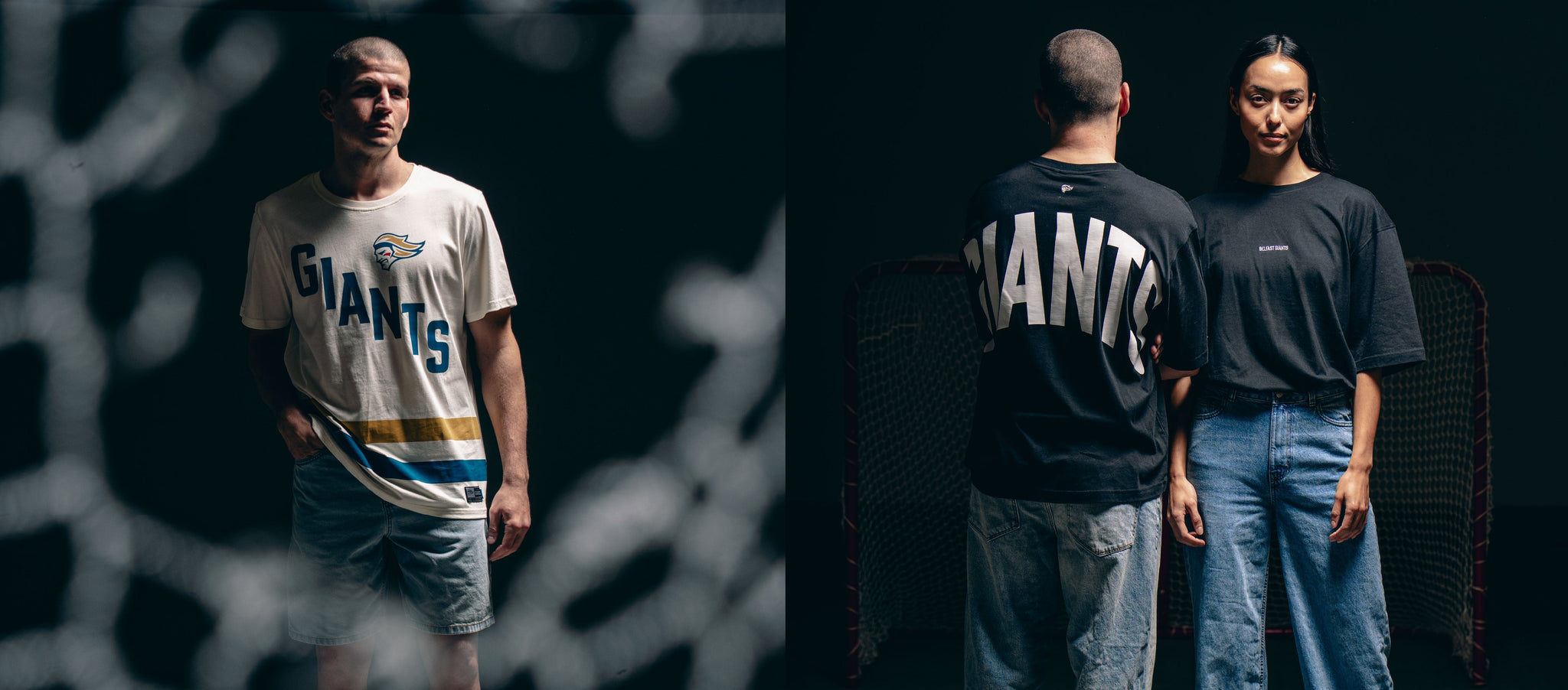 Two people wear casual GIANTS shirts and jeans. One man faces forward, while in another view, he stands back-to-back with a woman, both in front of a net with dramatic lighting.