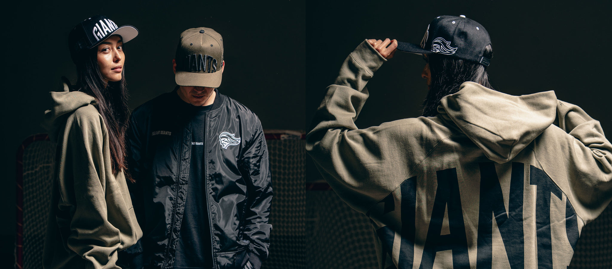 Two people in streetwear: one in a black cap and olive hoodie with GIANT on the back, the other in an olive cap and black jacket, standing in front of a dark background.
