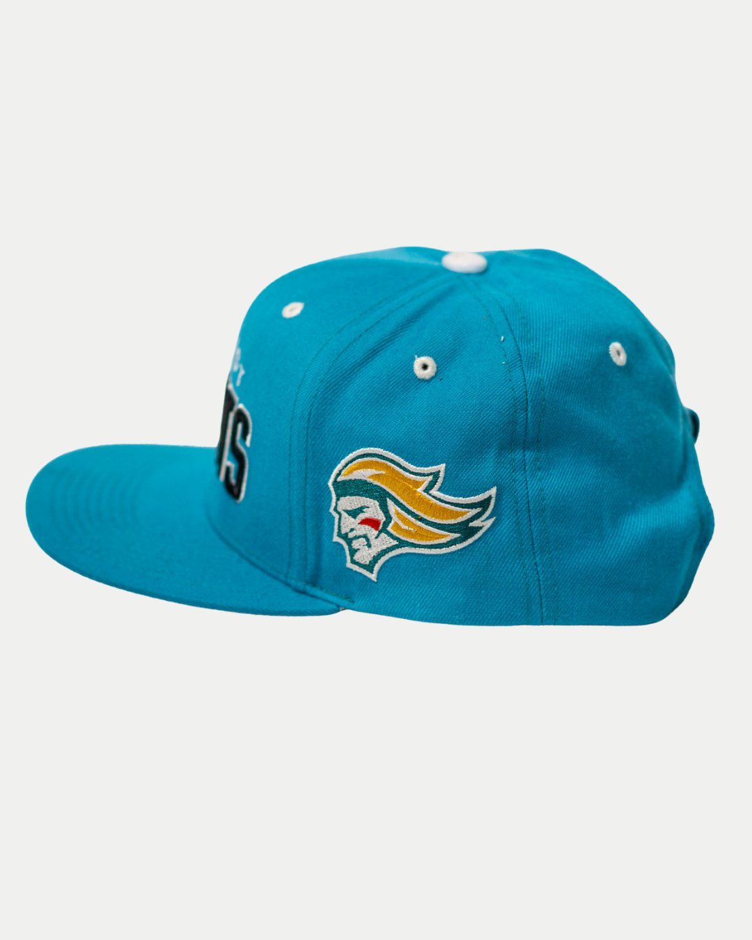 The Belfast Giants Teal Snapback Cap features a flat brim, white stitching, and a side crest logo with a stylized face and yellow, orange, and white hair. This official Belfast Giants hat stands out on a crisp white background.