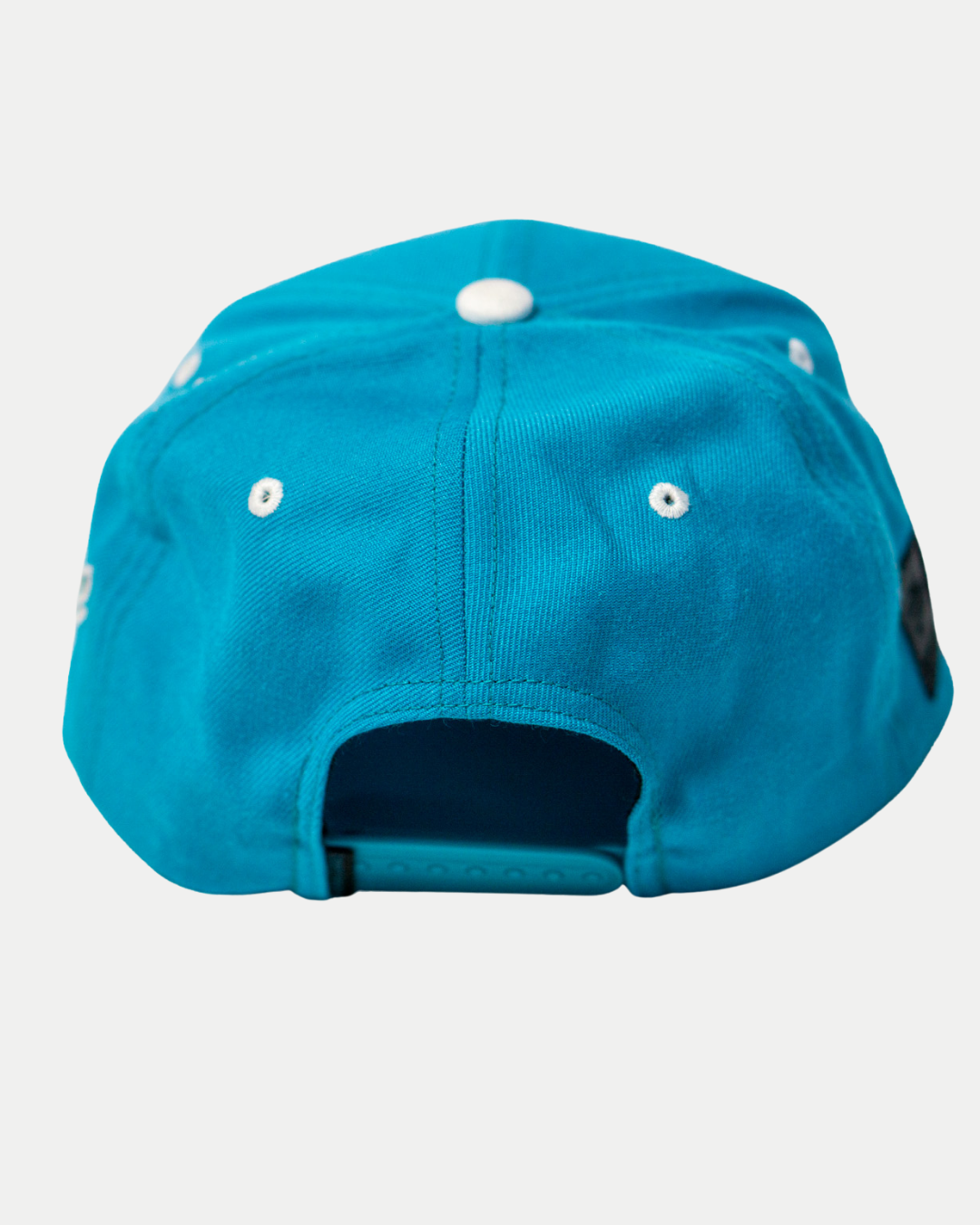 The Belfast Giants Teal Snapback Cap features a plastic adjustable strap, white eyelets, and a subtle team crest—ideal for fans wanting a stylish Belfast Giants hat.