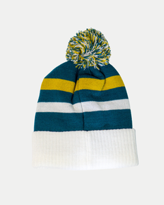 The Belfast Giants Hockey Beanie Off-White features blue, yellow, and white stripes, a ribbed white fold-over cuff, and a colorful pom-pom—ideal for winter matchdays. Shown against a plain light gray background.