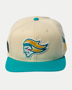 The Belfast Giants Hockey Cap Off-White by Belfast Giants features an off-white base, teal brim and button, and a front embroidered stylized head logo in yellow, teal, and white. Adjustable for comfort.