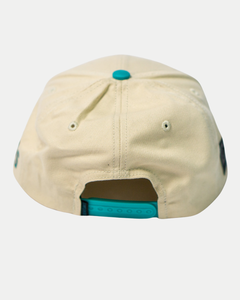 The Belfast Giants Hockey Cap Off-White by Belfast Giants features an adjustable blue snapback closure, metal eyelets for ventilation, and a stylish off-white design—ideal as a casual sports hat.