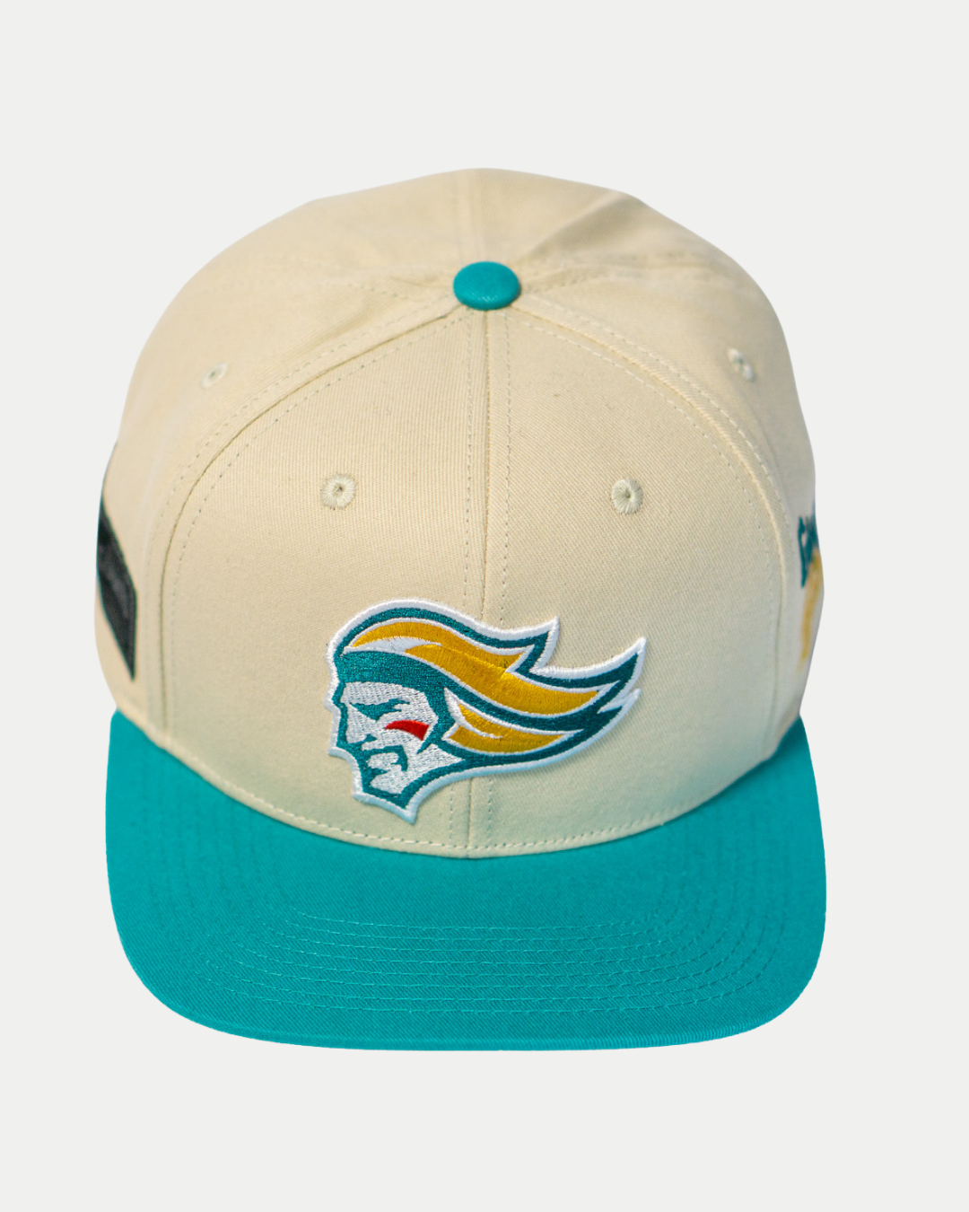 The Belfast Giants Hockey Cap Off-White is an adjustable sports hat by Belfast Giants, featuring a turquoise brim, button, and an embroidered stylized head logo with flowing yellow and teal hair on the front.