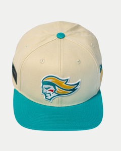 The Belfast Giants Hockey Cap Off-White is an adjustable sports hat by Belfast Giants, featuring a turquoise brim, button, and an embroidered stylized head logo with flowing yellow and teal hair on the front.