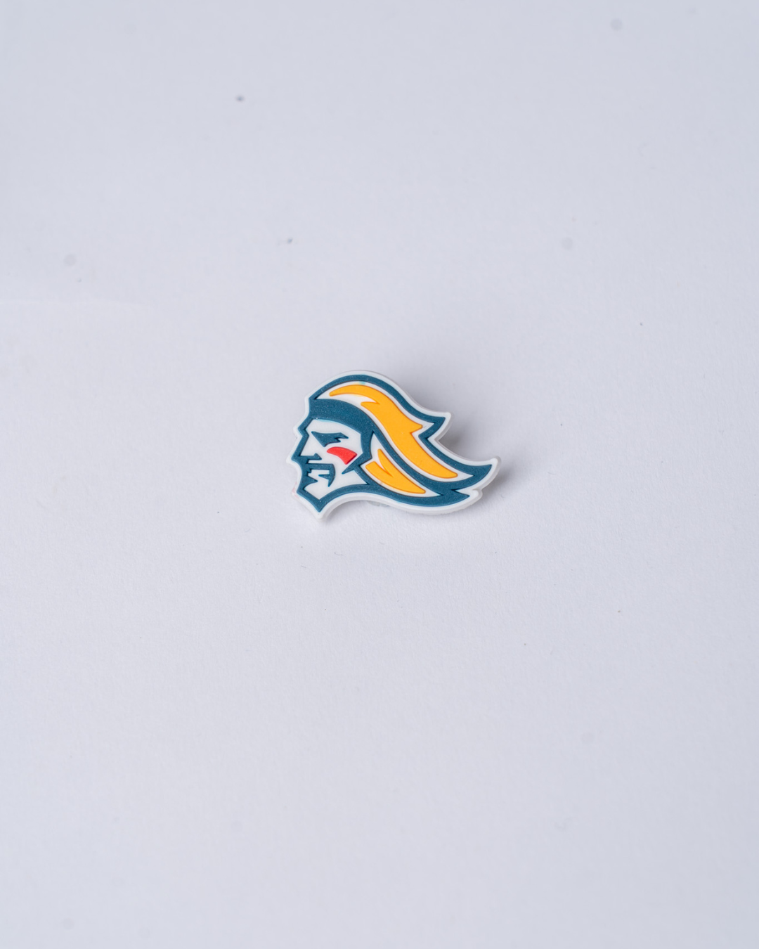 The Belfast Giant Croc Charms from Belfast Giants Store by National Merchandise feature a stylized profile with long yellow hair, a blue face, and a red cheek mark on a plain white background.