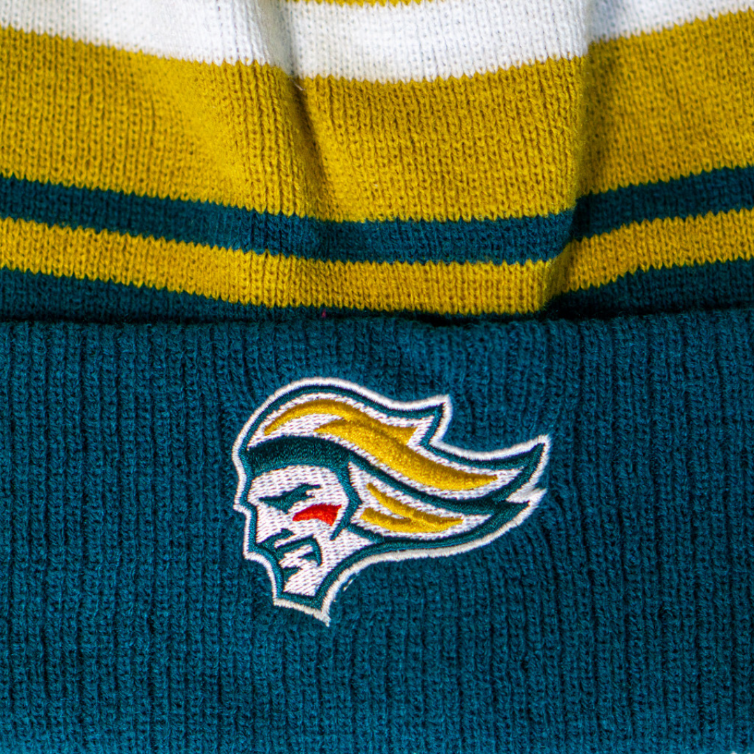 A close-up of the Belfast Giants Hockey Beanie Striped Gold by Belfast Giants, featuring gold, white, and teal stripes and an embroidered stylized team logo with yellow hair and a red mark on the cheek.