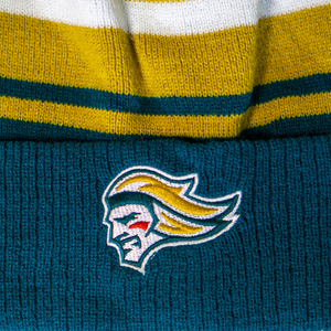 A close-up of the Belfast Giants Hockey Beanie Striped Gold by Belfast Giants, featuring gold, white, and teal stripes and an embroidered stylized team logo with yellow hair and a red mark on the cheek.