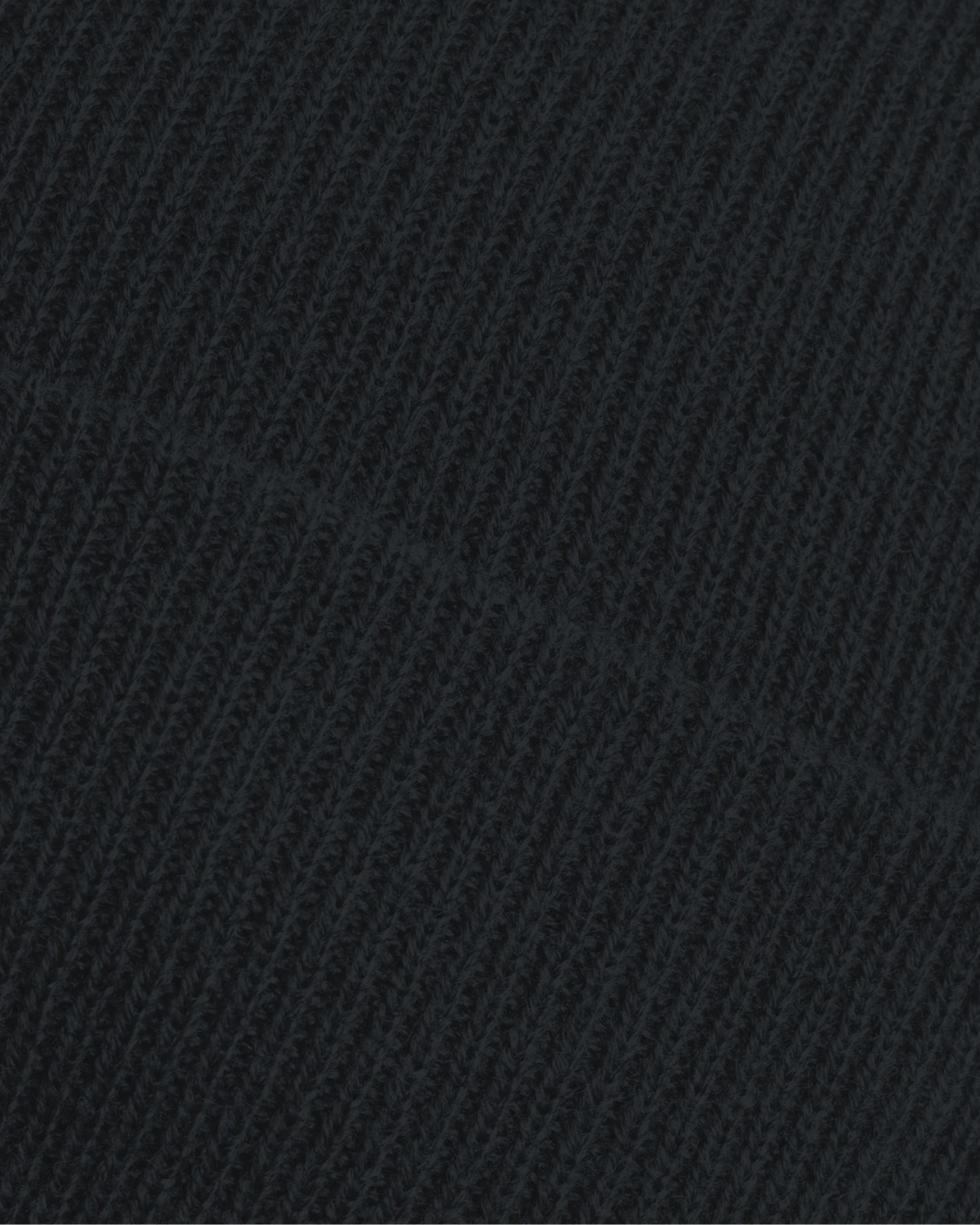 Close-up of black ribbed knit fabric from the Belfast Giants Made To Order Giants Logo Cuffed Beanie, showcasing its soft texture and diagonal seam detail.