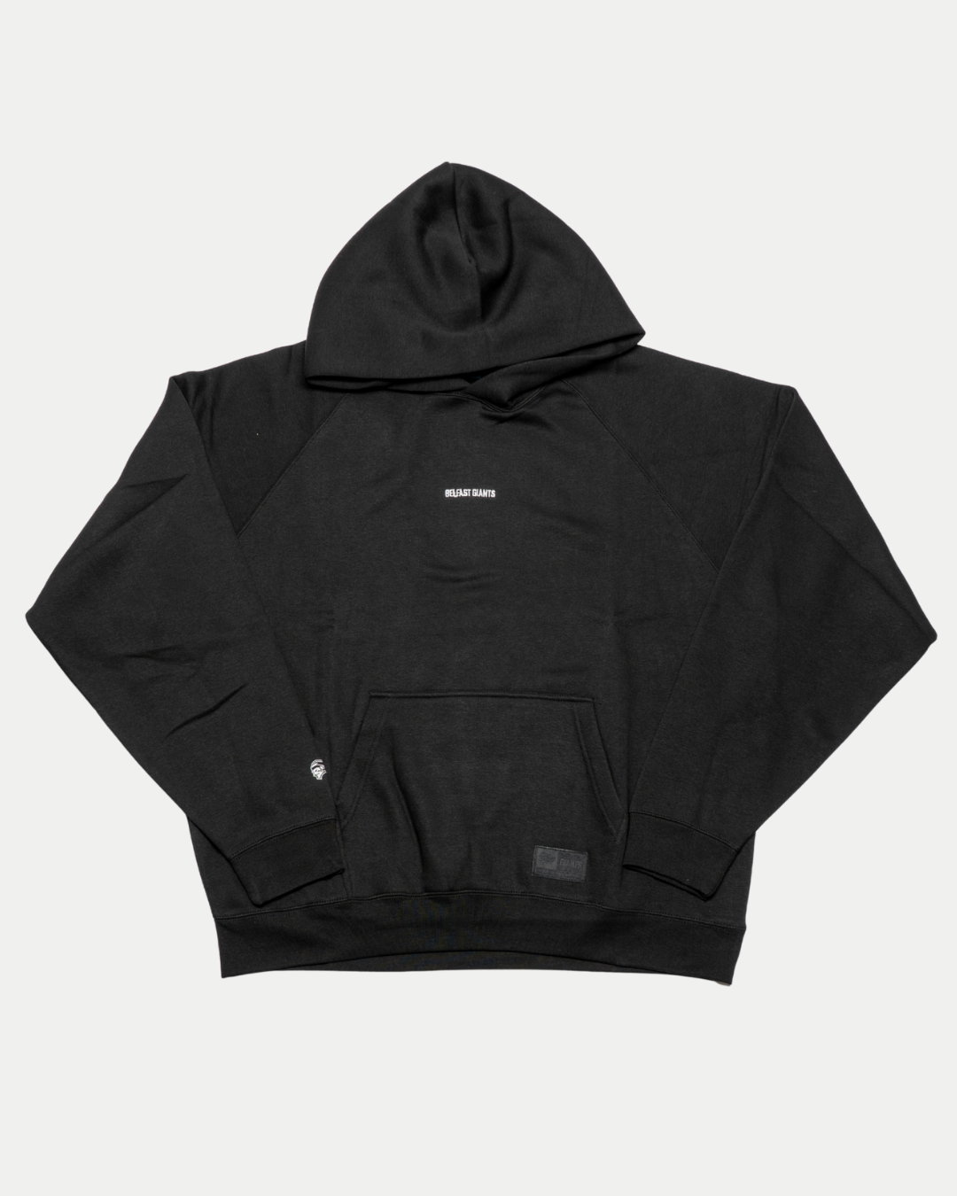The Belfast Giants Hoodie Black Backprint features a plain black design with a front pocket and "RELAX BABY" in small white text centered on the chest. Laid flat on a white background, it’s perfect for any Belfast Giants fan collection.