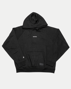 The Belfast Giants Hoodie Black Backprint features a plain black design with a front pocket and "RELAX BABY" in small white text centered on the chest. Laid flat on a white background, it’s perfect for any Belfast Giants fan collection.