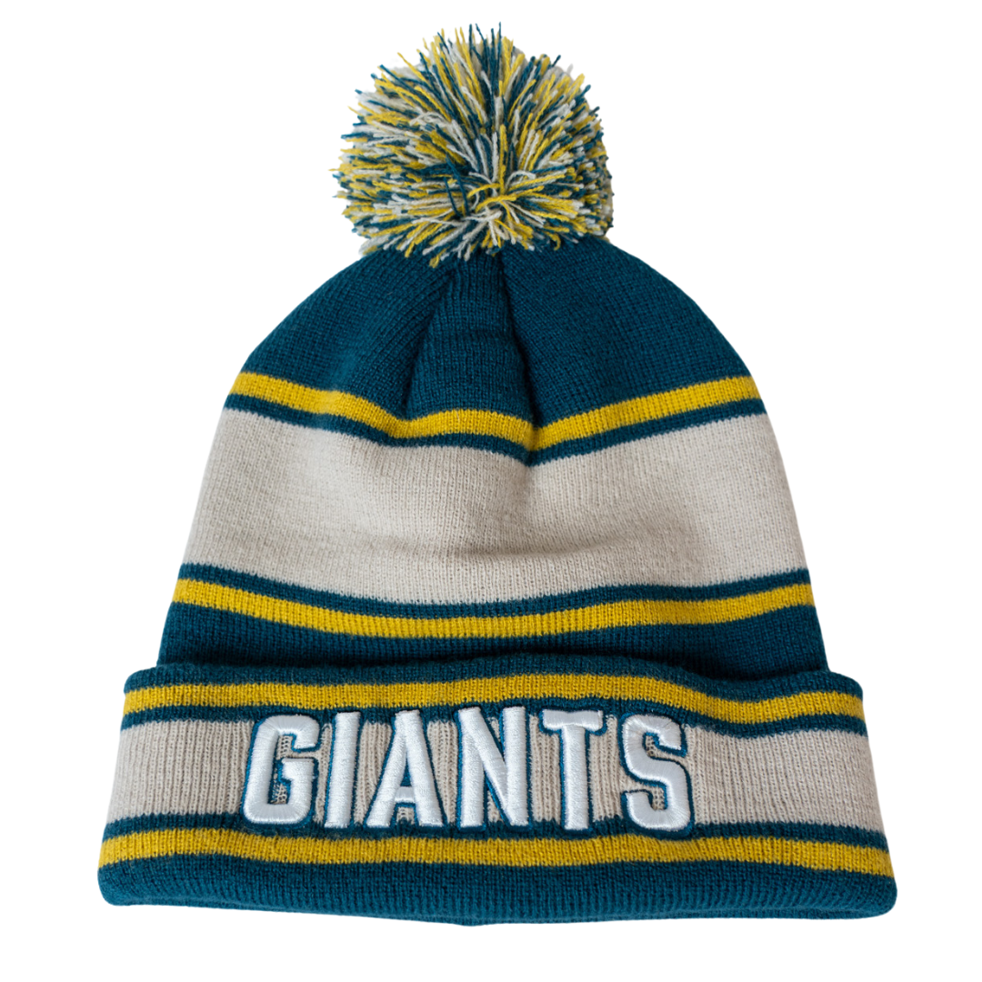 The Belfast Giants Beanie Cream/Teal is a knitted hat with teal, white, and yellow stripes, a pom-pom on top, and GIANTS embroidered in bold white letters on the folded brim.