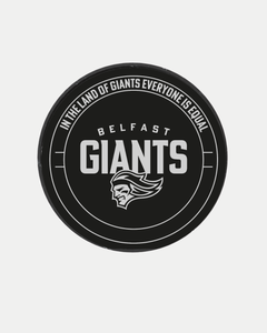 The Belfast Giants Statue Puck is a black hockey puck featuring the Belfast Giants brand and a white stylized face logo, with "In the land of giants everyone is equal" around the edge.