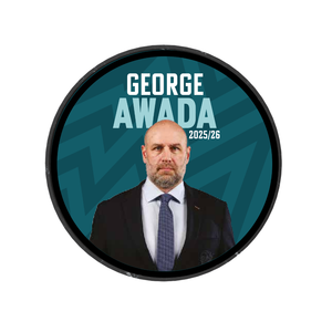 A man in a suit and tie stands before a teal background with bold “GEORGE AWADA 2025/26” text. Framed in a black circle, this image celebrates the Belfast Giants’ limited edition 2025-26 Player Puck.