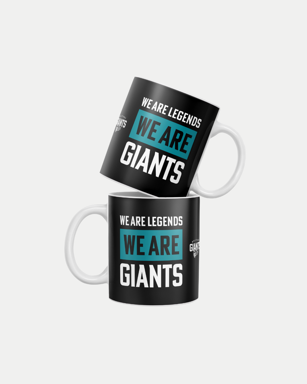 Two black ceramic "We Are Legends, We Are Giants" mugs by Belfast Giants, each with a white handle and bold teal and white text. Made-to-order to reduce waste. Shown stacked against a plain white background.