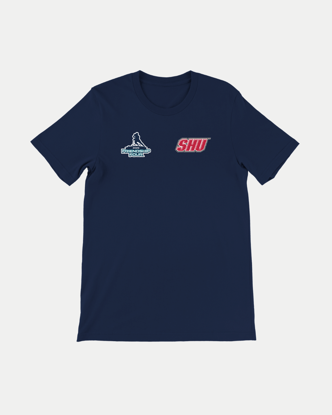The MADE-TO-ORDER Friendship Four 2025 Sacred Heart University T-Shirt by Belfast Giants is navy blue with two chest logos: a hockey player reading "Frozen Pond Series" and the red and white SHU logo. Made from 100% Airlume cotton.