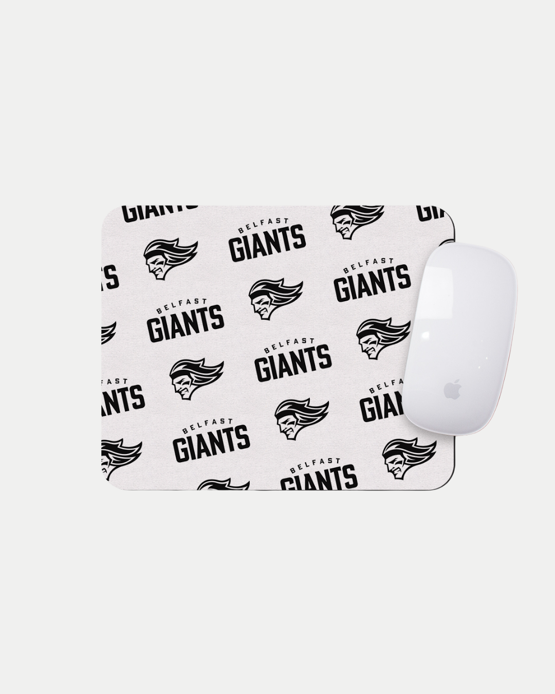 The Belfast Giants Multiple Logo White Mousemat features repeating black team text and a stylized giant head logo. This made-to-order accessory helps reduce waste and is shown with a white Apple Magic Mouse on top.