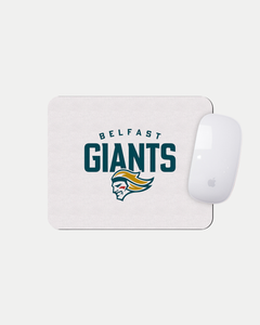The Belfast Giants Logo White Mousemat by Belfast Giants features a fierce green, gold, and white giant head logo on a made-to-order white mat—custom crafted to reduce waste. An Apple Magic Mouse rests in the top-right corner.