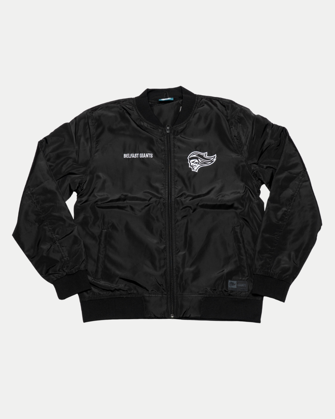 The Belfast Giants Bomber Jacket Black Backprint features ribbed cuffs and collar, a front zipper, side pockets, BELFAST GIANTS text, and a stylized head logo on the front left side.