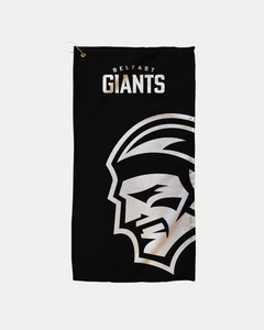 The Belfast Giants Logo Black Golf Towel features bold white team text and a large stylized warrior's face. Made-to-order by Belfast Giants to reduce waste, with delivery details shown at checkout.