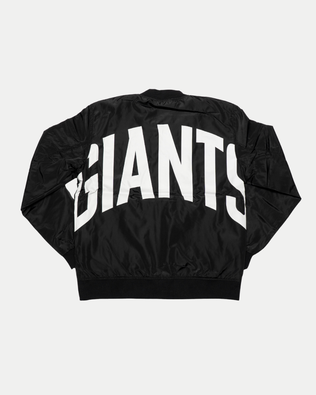 The Belfast Giants Bomber Jacket Black Backprint by Belfast Giants is a black bomber jacket featuring large, bold white "GIANTS" lettering across the back, shown here displayed flat.