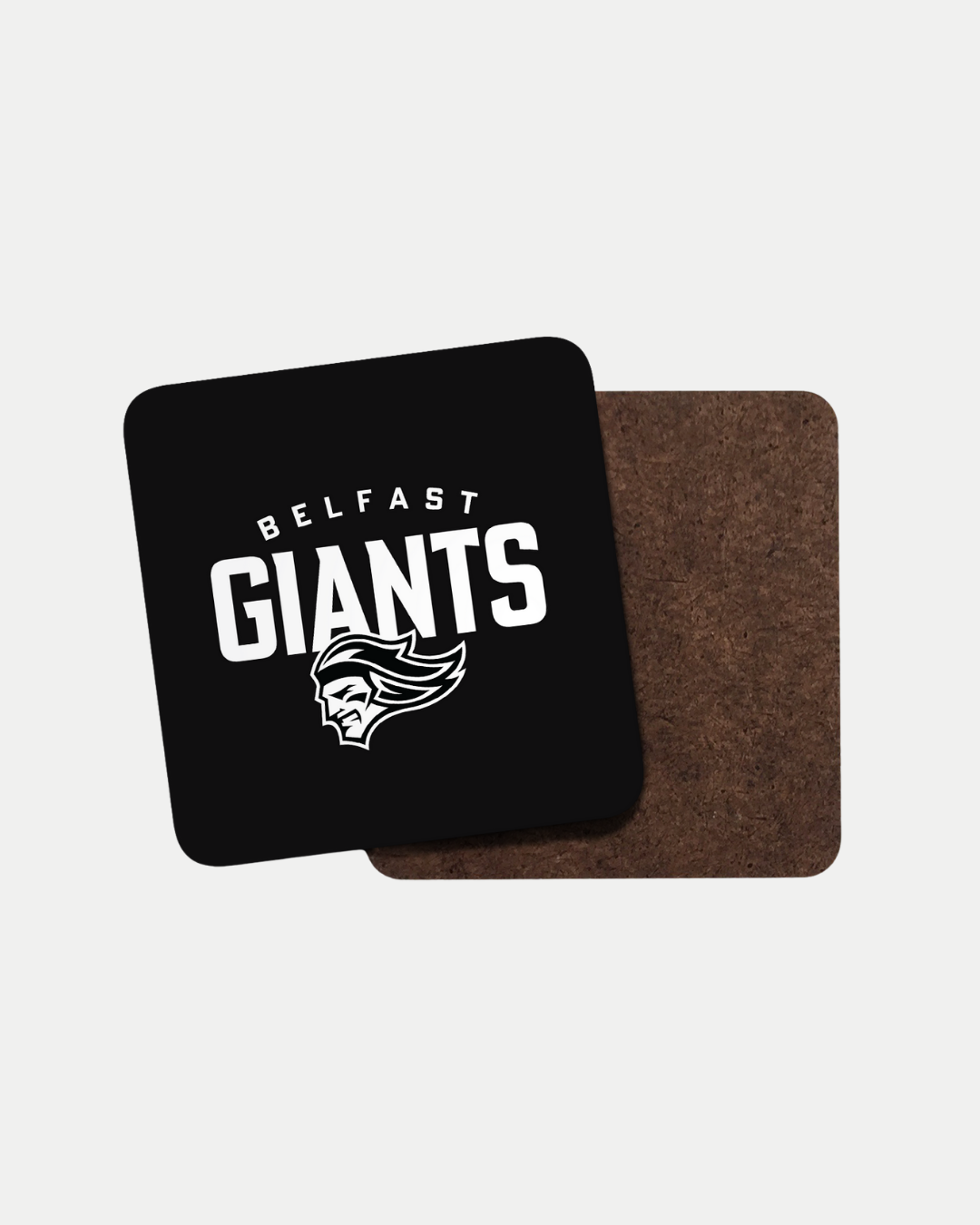 The Giants Black Logo Coaster by Belfast Giants features a black front with BELFAST GIANTS in white above a stylized giants head logo, shown next to the plain brown back. Each coaster is crafted on order to help reduce waste.