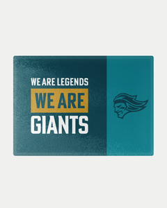 The We Are Legends Chopping Board by Belfast Giants features a split teal background, bold gold "GIANTS" text, and a helmeted figure on the right. Crafted to order, this rectangular board is perfect for fans and kitchens alike.