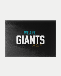 The We Are Giants Black Chopping Board by Belfast Giants features bold white and blue "WE ARE GIANTS" lettering and a gold signature, crafted to order for a personalized touch.