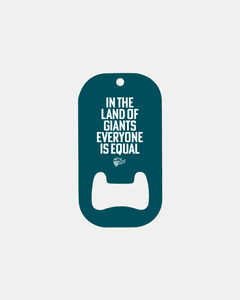 The Belfast Giants "In The Land Of Giants" Bottle Opener is a custom dark teal opener with white lettering and a small logo, shown on a plain white background.