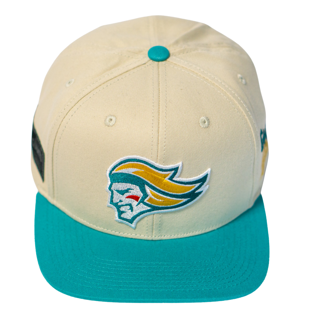 The Belfast Giants Hockey Cap Off-White by Belfast Giants features an off-white design with a teal brim and button, adjustable fit, and an embroidered stylized face logo with flowing yellow hair on the front.
