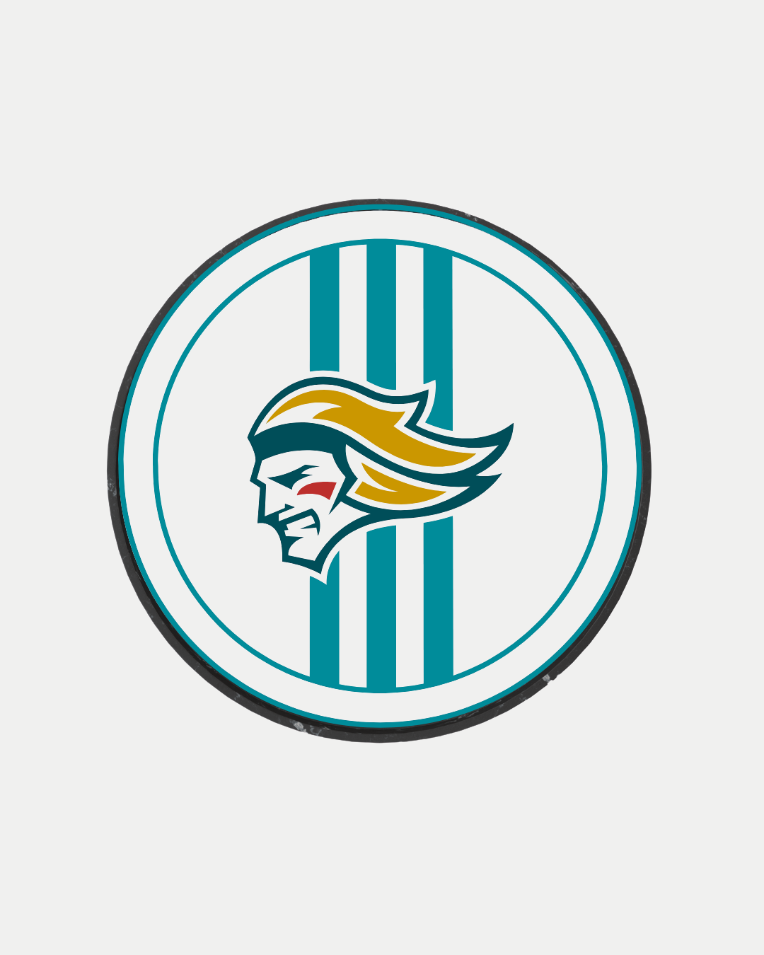 The 24-25 White Stripe Logo Puck by Belfast Giants features a circular design with teal vertical stripes and a stylized golden-haired warrior’s profile—marked by a bold red cheek streak—set on a crisp white background.