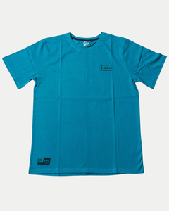 The Belfast Giants Teal T-Shirt Black Badge features short sleeves, a small rectangular Giants patch on the left chest, and another near the bottom hem, shown against a white background.