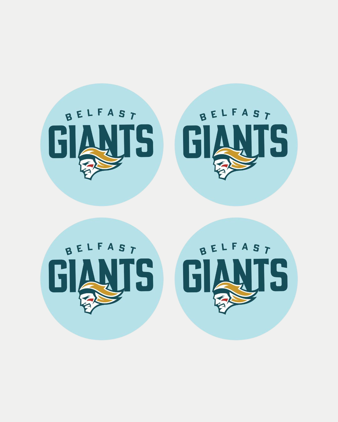 The Belfast Giants set of 4 puck coasters features identical circular logos on a light blue background, with "Belfast Giants" above a stylized bearded helmeted figure in vibrant yellow, teal, and red accents.