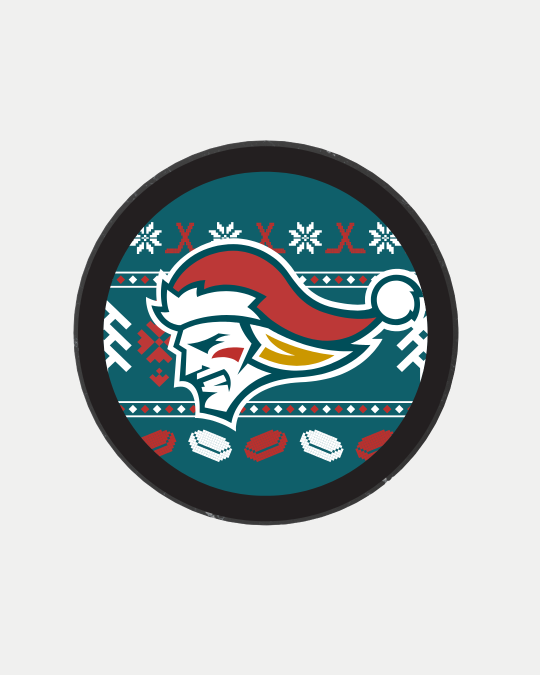 The Christmas Logo Puck from Belfast Giants Store by National Merchandise features a circular logo with a stylized head in a Santa hat, surrounded by festive patterns, snowflakes, hockey sticks, and pucks on a teal background.