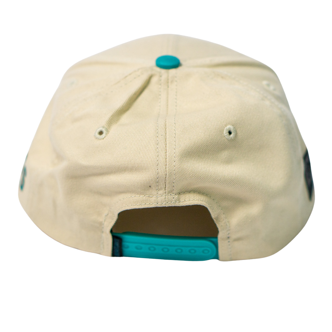 The Belfast Giants Hockey Cap Off-White features a teal adjustable snapback closure and a matching teal top button, shown from the back.