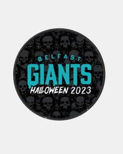 The Belfast Giants Halloween Skull Puck features a circular design with a black background, scattered skull patterns, and "Belfast Giants Haunted Halloween 2023" in turquoise and white.