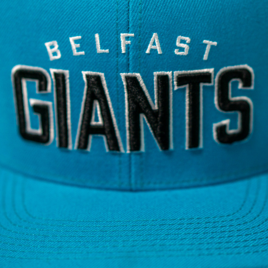 Close-up of the Belfast Giants Teal Snapback Cap by Belfast Giants, featuring white and black embroidered BELFAST GIANTS lettering and the team’s iconic crest on the front.