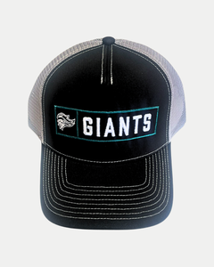 The 25-26 CCM Trucker Cap from Belfast Giants Store by National Merchandise is a black and gray mesh cap with white stitching, featuring a front patch with a stylized face logo and bold white "GIANTS" lettering.
