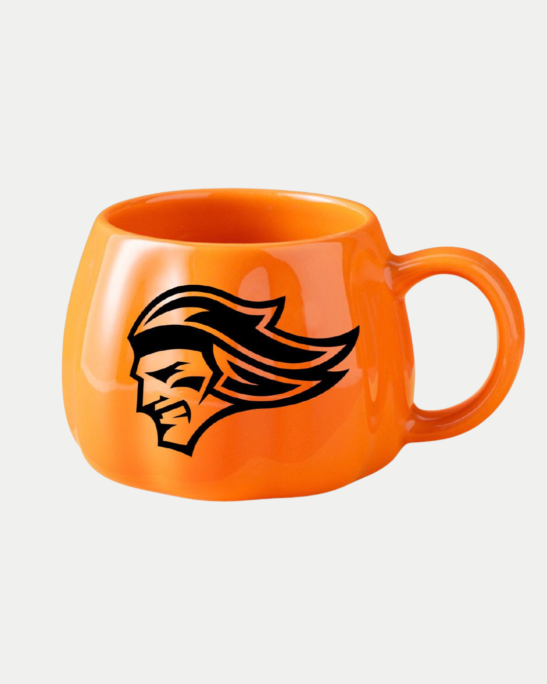 The Belfast Giants Pumpkin Mug by Belfast Giants is a bright orange Halloween mug with a handle, showcasing a bold black stylized face in profile with flowing hair, set against a plain white background.