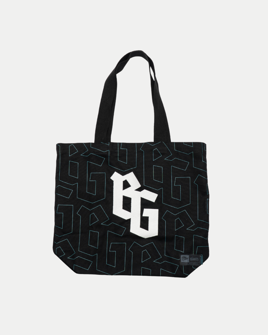 The Belfast Giants Tote Bag BG Logo by Belfast Giants is a black tote with thick handles, a bold white BG logo centered, and an all-over geometric pattern outlined in dark blue and teal.