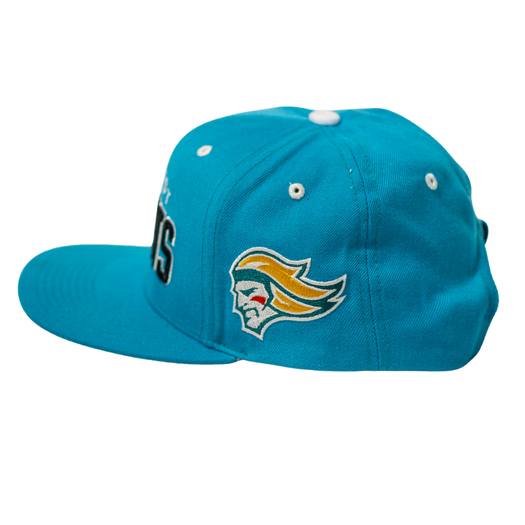 The Belfast Giants Teal Snapback Cap by Belfast Giants features an embroidered team crest with a stylized yellow-haired head on the side, a flat brim, and multiple white eyelets on top.