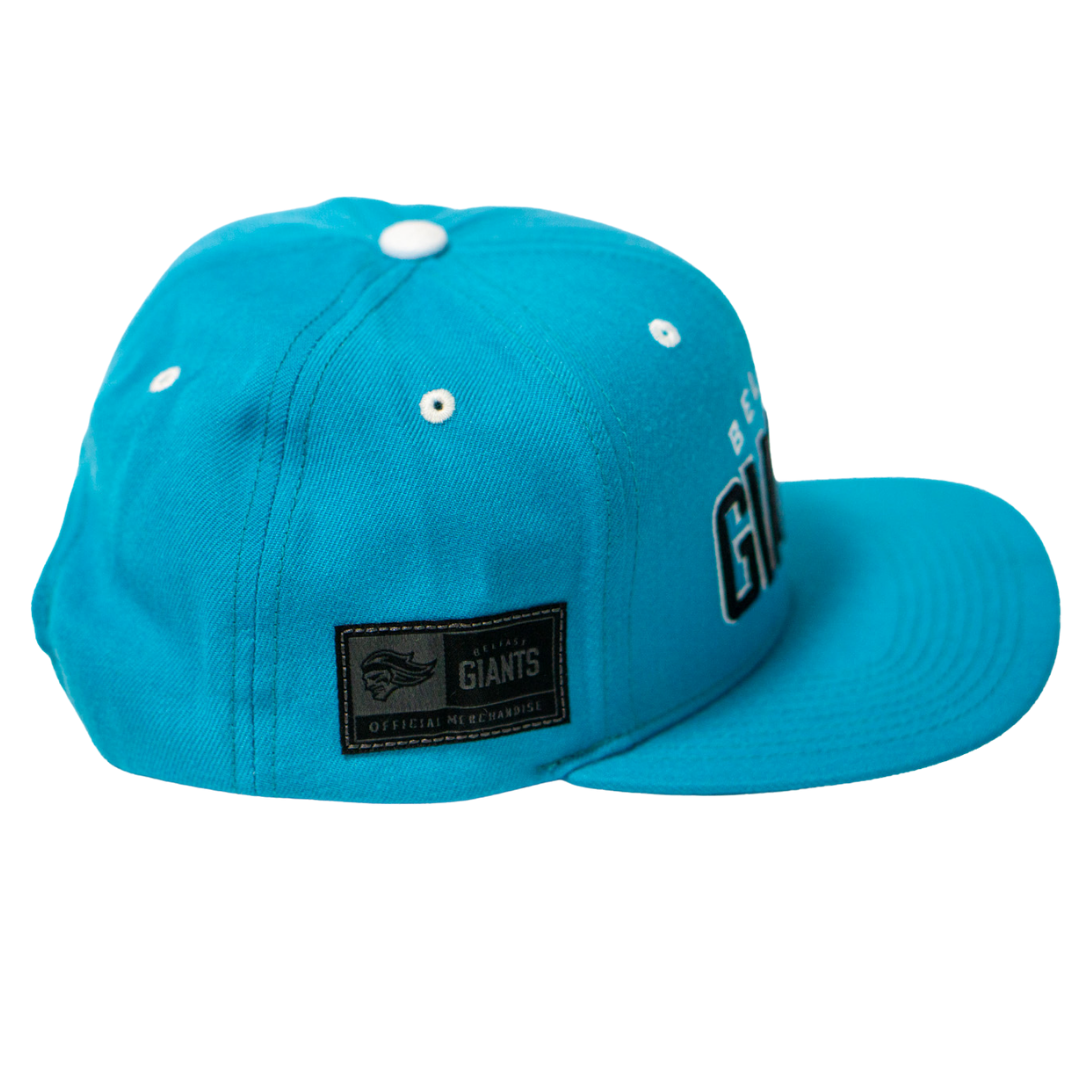 The Belfast Giants Teal Snapback Cap features white eyelets, a flat brim, an OFFICIAL MERCHANDISE side patch, and a partially visible GIANTS team crest on the front.