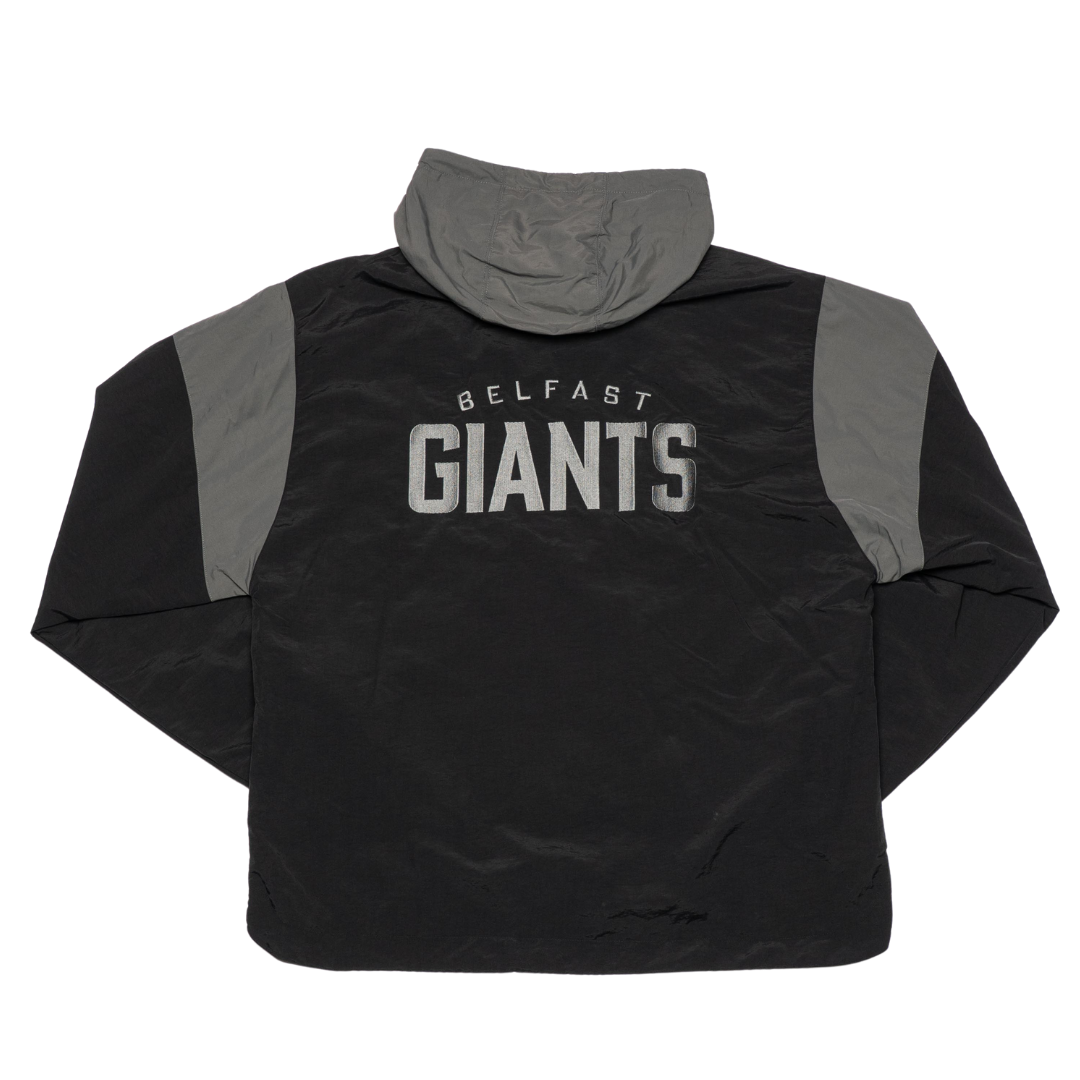 The Belfast Giants Anorak Black is a stylish half-zip jacket with gray sleeves, a high collar, and BELFAST GIANTS in bold white and gray letters on the back—ideal for fans in cold weather.