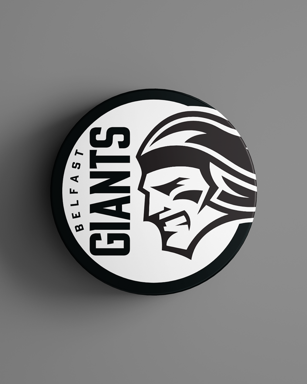 The Belfast Giants Black Logo Puck 25-26 from Belfast Giants Store by National Merchandise features the team logo, including a stylized giant’s face and bold GIANTS lettering, on a sleek black puck.