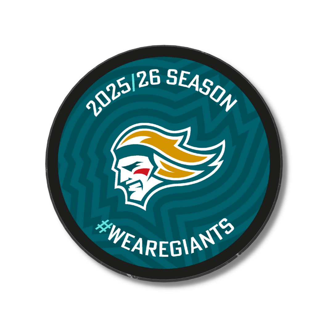 The Logo Season Puck Gold 25-26 from Belfast Giants Store by National Merchandise features a giant head logo with yellow hair, 2025/26 SEASON at the top, #WEAREGIANTS at the bottom, and a teal wavy background.
