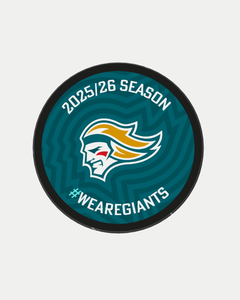 The Logo Season Puck Gold 25-26 from the Belfast Giants Store by National Merchandise features a circular teal logo with a stylized giant’s head, bold yellow hair, “2025/26 SEASON” at the top, and “#WEAREGIANTS” at the bottom.