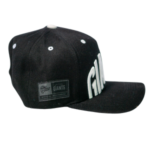 The Belfast Giants Cap Black and White by Belfast Giants features bold white GIANTS lettering on the front, a flat brim, and an official merchandise patch—an essential for any Belfast Giants supporter.
