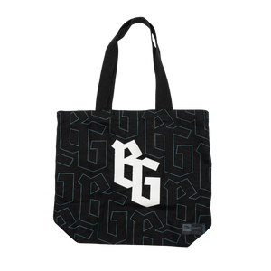 The Belfast Giants Tote Bag BG Logo features a black design with large white stylized BG letters, a blue Giants-inspired print, two handles, and a small bottom-corner label.
