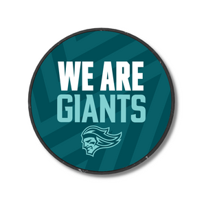 The We Are Giants Teal Logo Puck 25-26 from Belfast Giants Store features a dark teal zigzag background, white and light teal WE ARE GIANTS text, and a stylized giant head logo at the bottom.