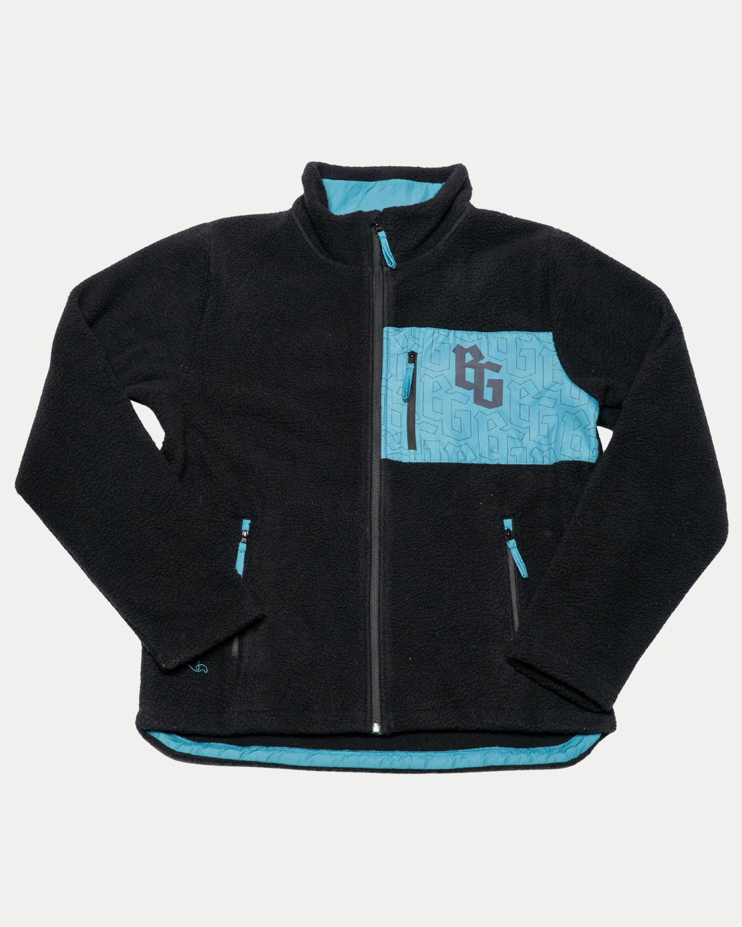 The Belfast Giants Pile Jacket BG Logo is a black fleece-lined jacket with turquoise accents, including a zippered chest pocket featuring the BG logo, side pockets, interior lining, and a subtle geometric pattern on the turquoise areas.